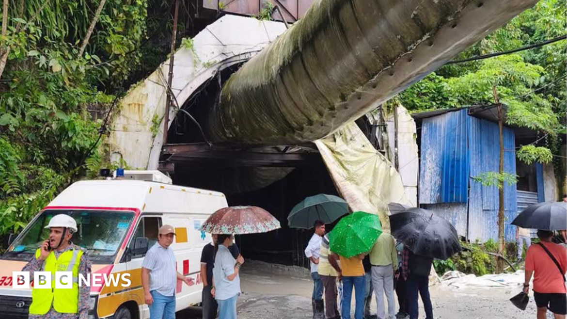 Rescue officials and locals could be seen standing near the tunnel site - with workers trapped in the under-construction