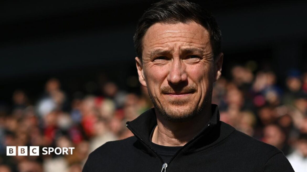 Stuart Maynard looks on wearing a black jumper