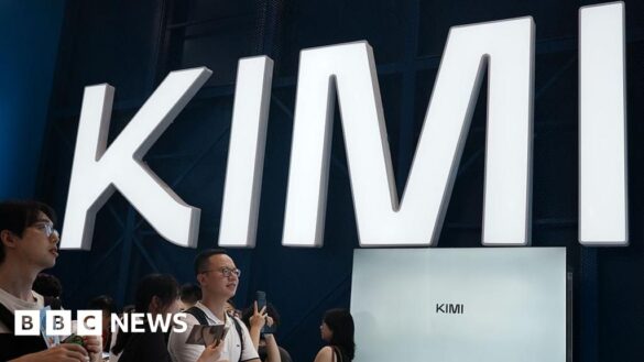 Visitors at a trade show in Shanghai visit a booth with the Kimi sign displayed in large block letters