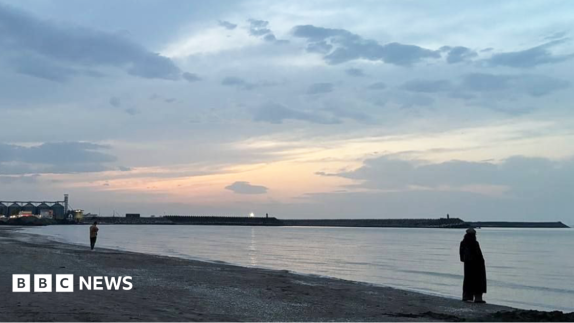 A woman stands on a Caspian Sea beach in Iran. File photo