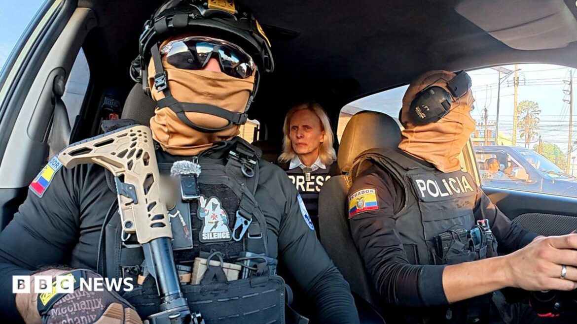 Two Ecuadoran police officers in dark sunglasses, helmets and balaclavas - which entirely obscure their faces - sit in a car