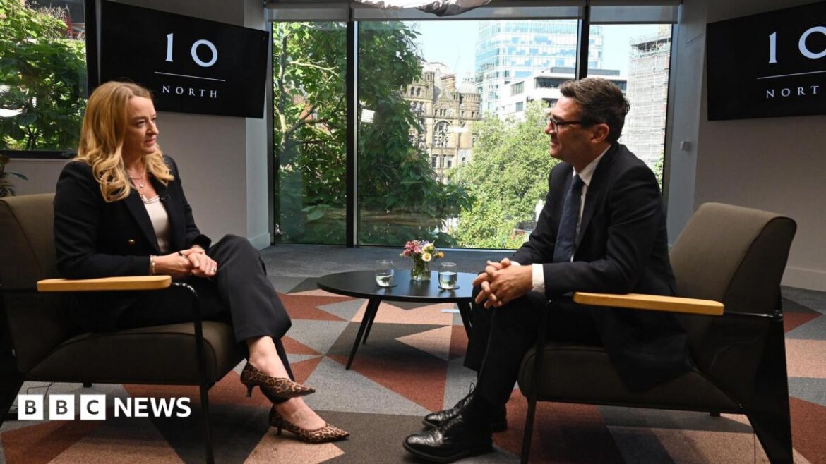 Andy Burnham and Laura Kuenssberg sit opposite one another on brown chairs with a coffee table between them, on top of which