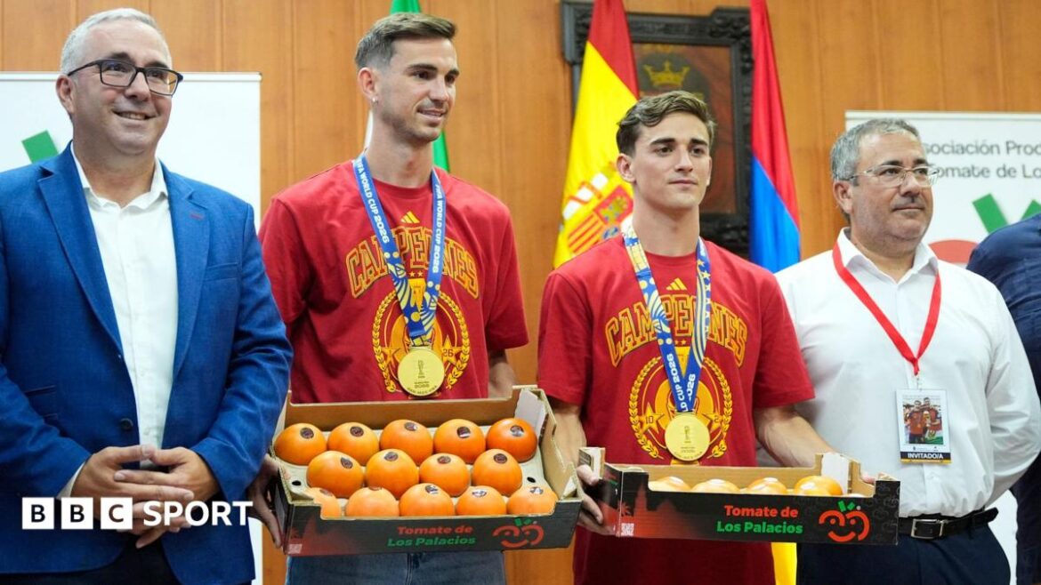 Spain midfielders Fabian Ruiz and Gavi holding a box of tomatoes on a visit back to the hometown of Los Palacios y