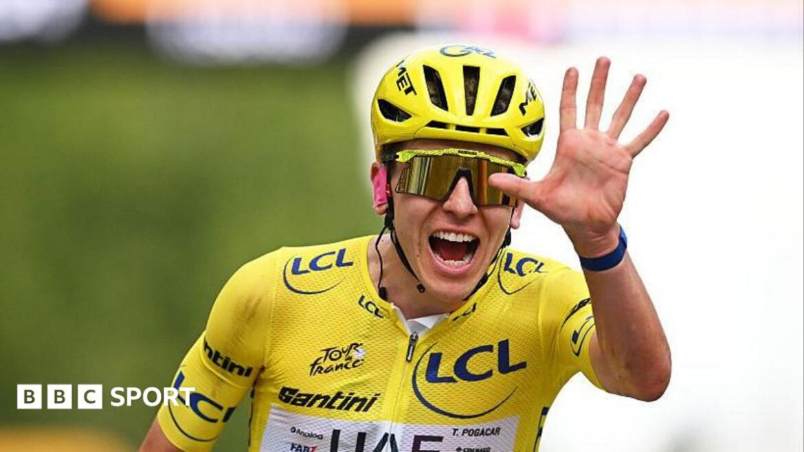 Tadej Pogacar celebrates winning a fifth Tour de France by showing five fingers