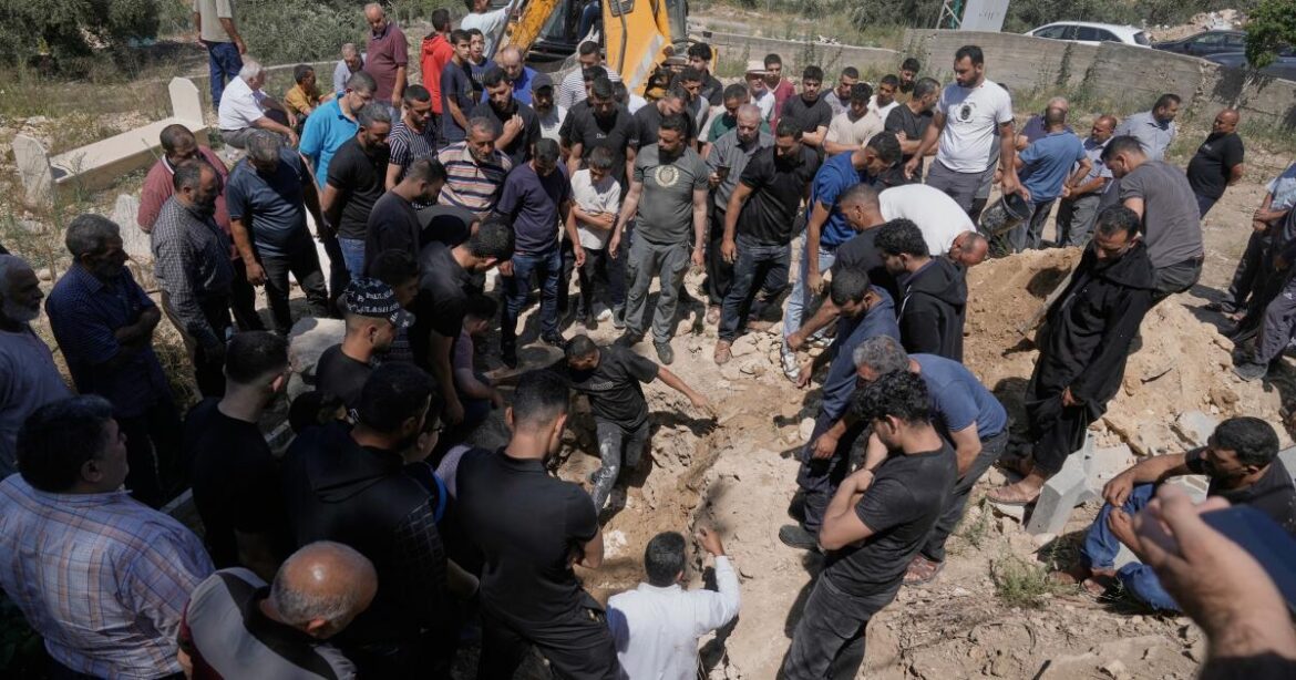 Mourners bury the body of Palestinian Mustafa al-Khatib, 32 who was killed during an Israeli army raid at his home in the