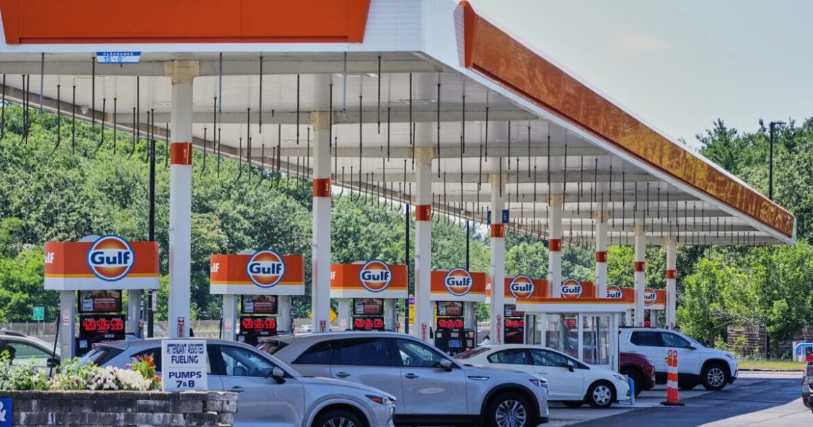 FILE - Cars line up at the pumps of a Gulf Oil station on the Massachusetts Turnpike near Boston, Sunday, July 19, 2026. (AP