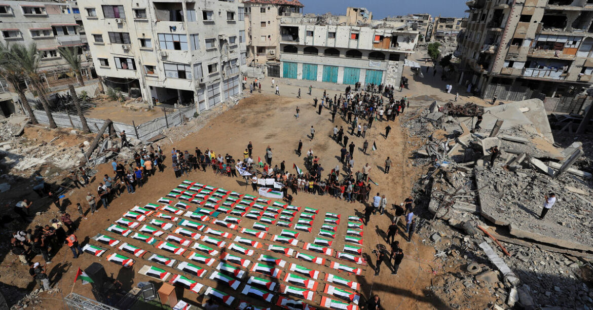 Palestinians attend the funeral of 112 members of the Hassayna and Abu Sharia clan, who were killed in an Israeli strike in