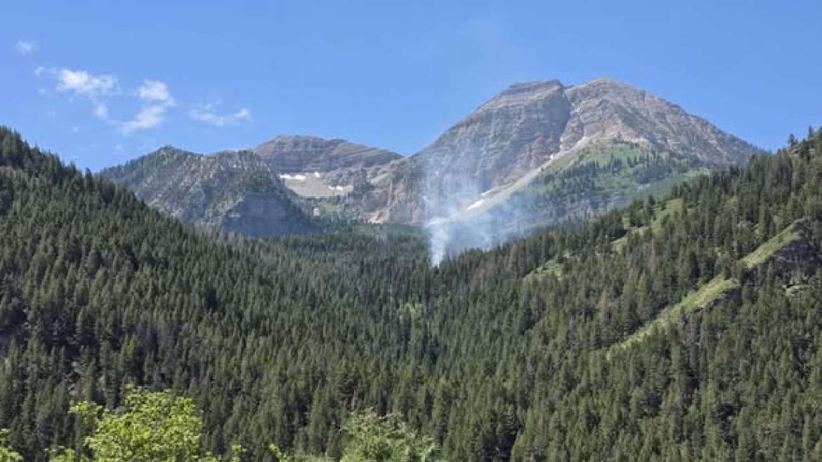 Smoke is visible from the Timp Fire, which began on July 10. A man who police say "has an extensive history with starting