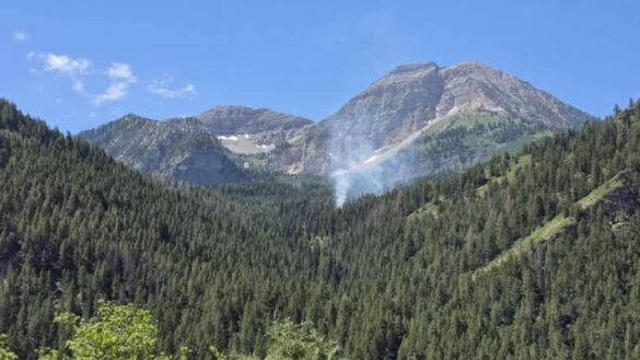 Smoke is visible from the Timp Fire, which began on July 10. A man who police say "has an extensive history with starting