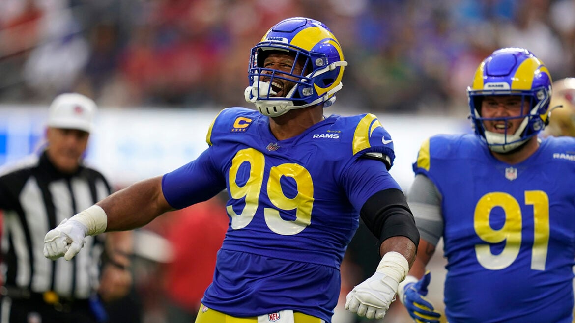 Los Angeles Rams defensive tackle Aaron Donald, left, celebrates after a sack as defensive tackle Greg Gaines watches during