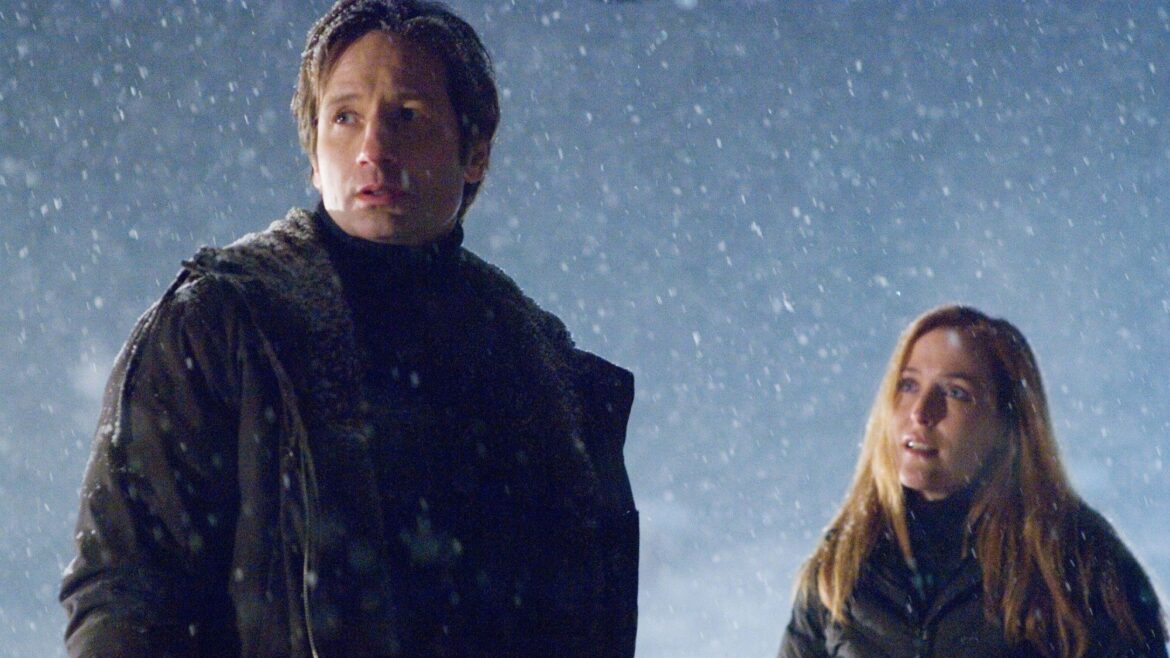 a man in winter clothing looks confused outside in the snow