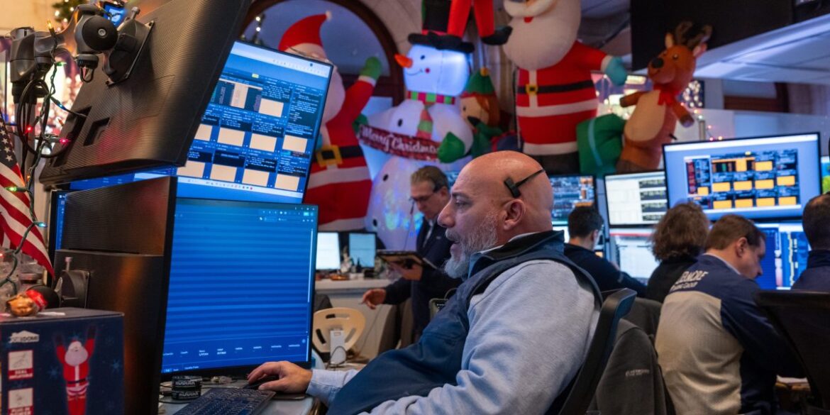 Traders work on the floor of the New York stock Exchange during a shortened trading day before the Christmas holiday on