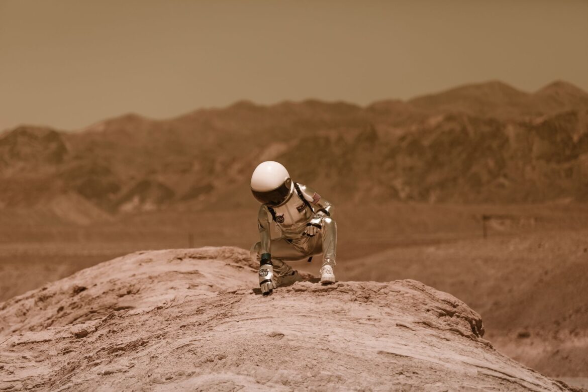 Representative staged image of an astronaut in a red desert landscape on Earth