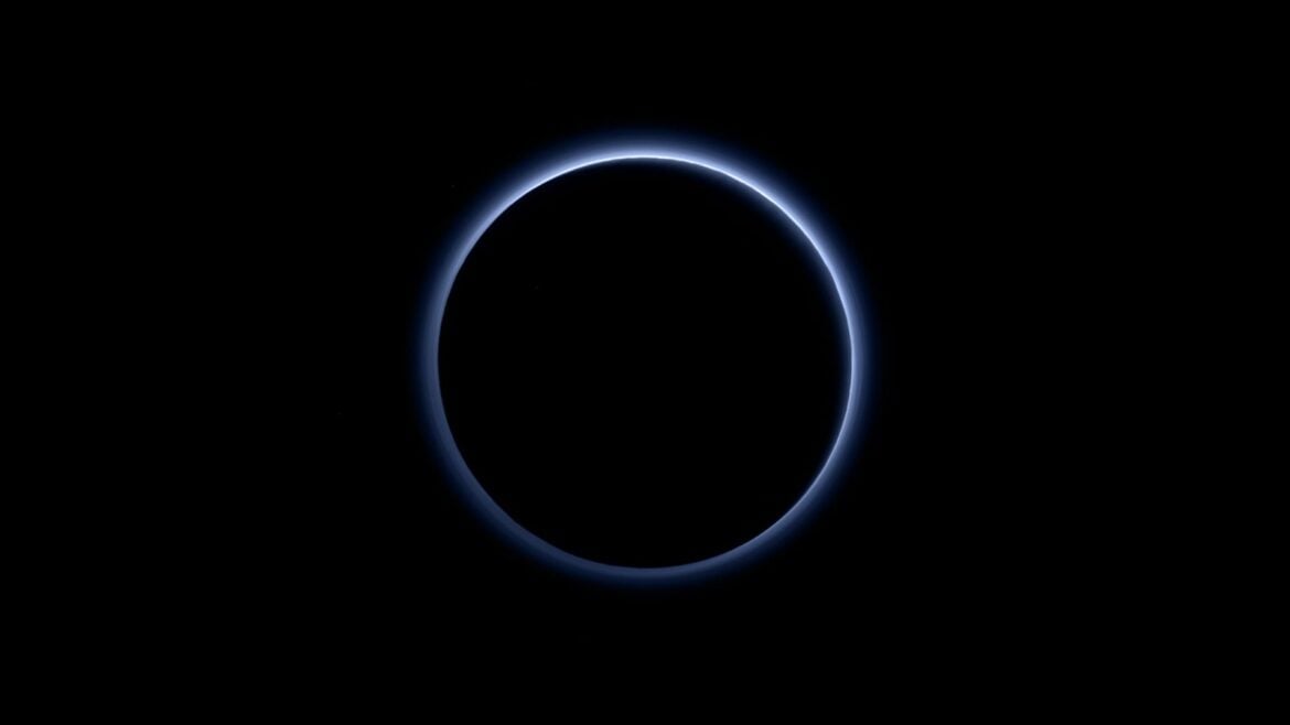 New Horizons view of Pluto as a dark disc surrounded by a thin blue atmospheric haze