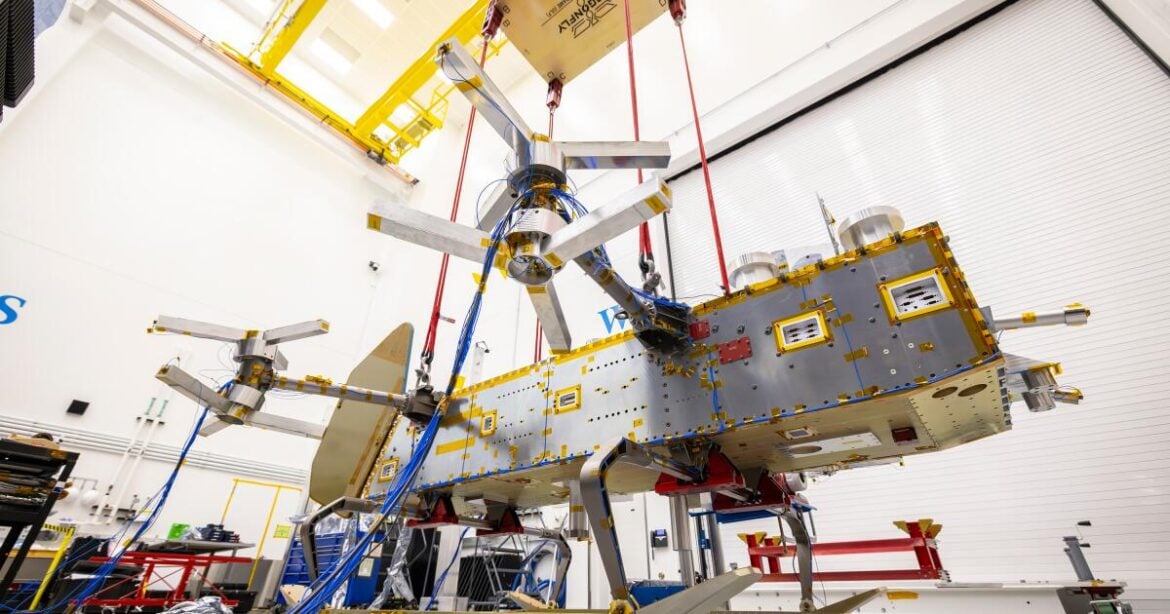 Suspended by four bungee cords, the Dragonfly structure is positioned inches above the floor during ground vibration tests