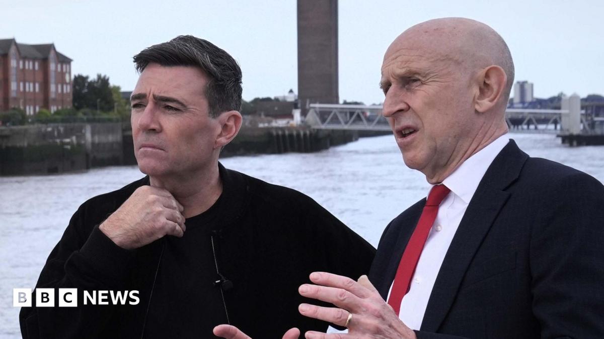John Healey makes a point with his hands to a thoughtful looking Andy Burnham, who is gazing out across the Mersey river on