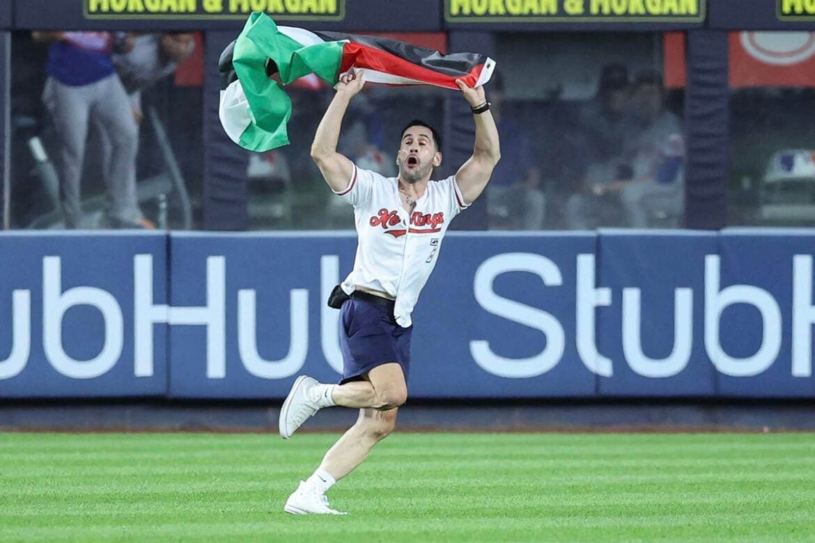 Protester waves Palestinian flag at Yankee Stadium during 9/11 anniversary