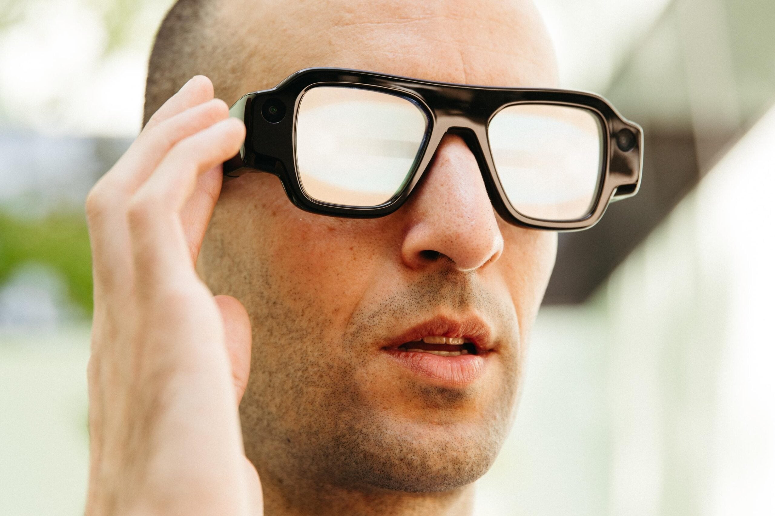 A photo of The Verge’s Jay Peters wearing Snap’s Specs AR glasses