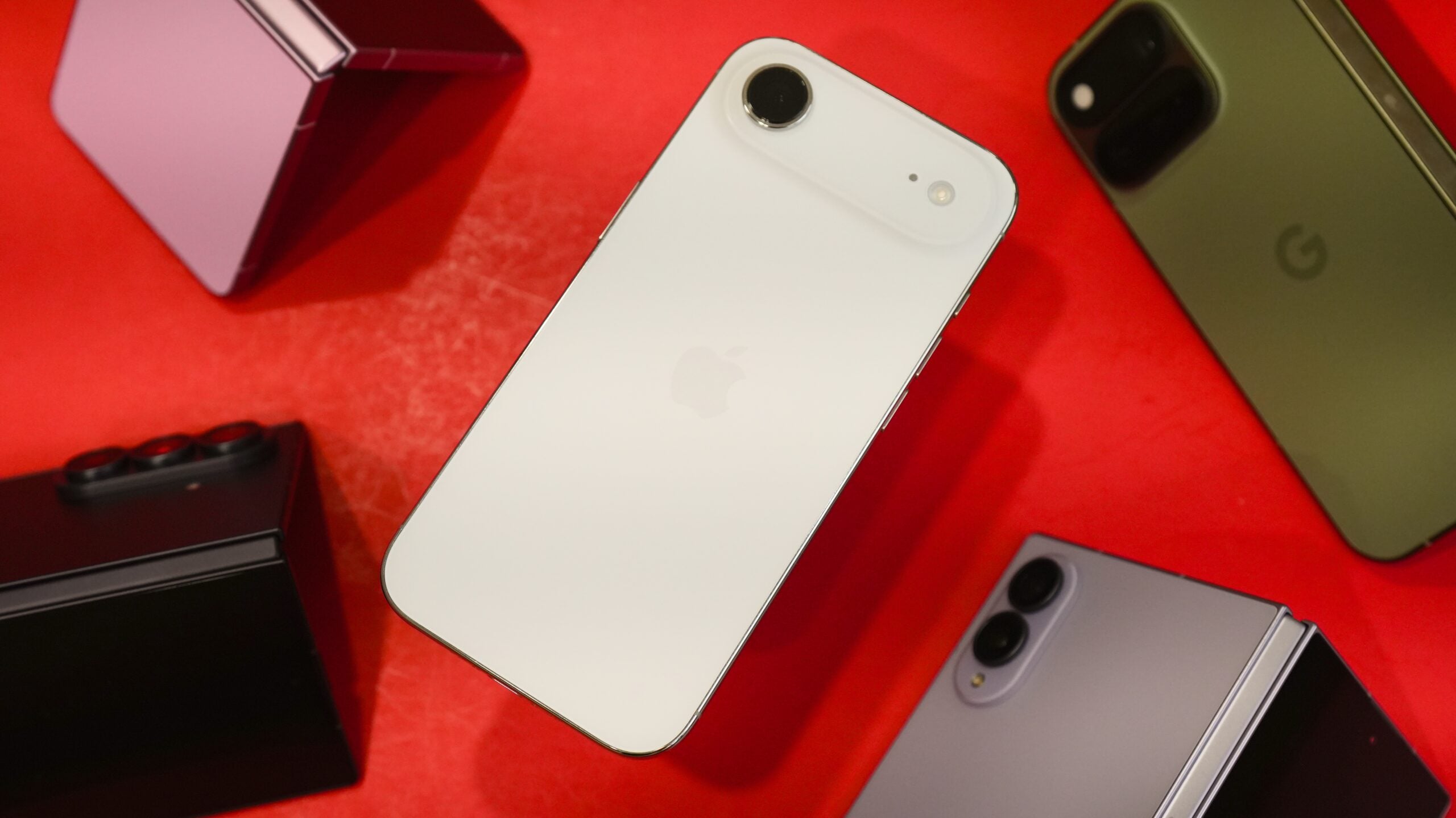 The iPhone Air surrounded by various Android foldable phones