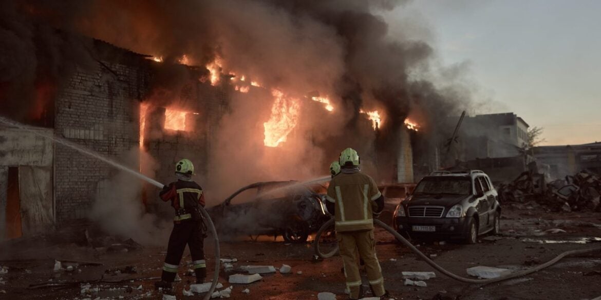 Members of emergency services work to contain a fire in the aftermath of a Russian missile and drone attack on September 8