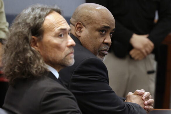 Duane Davis, right, and his attorney Michael Sanft sit in a courtroom after a jury found Davis guilty of first-degree murder