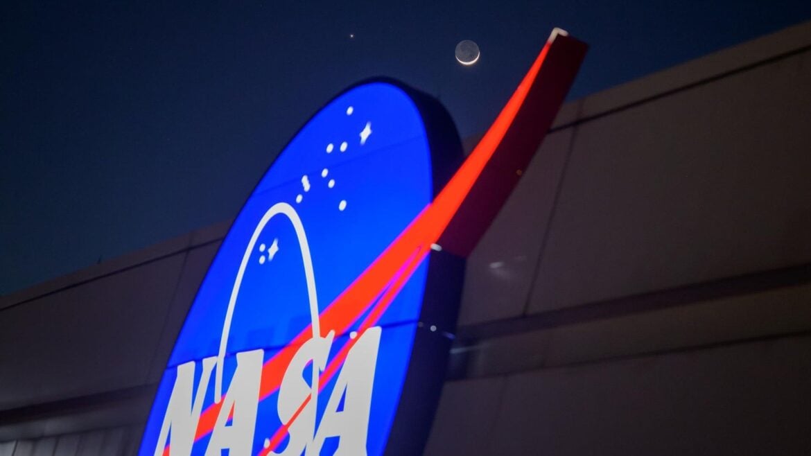 The crescent moon and Venus shine in the night sky above the NASA