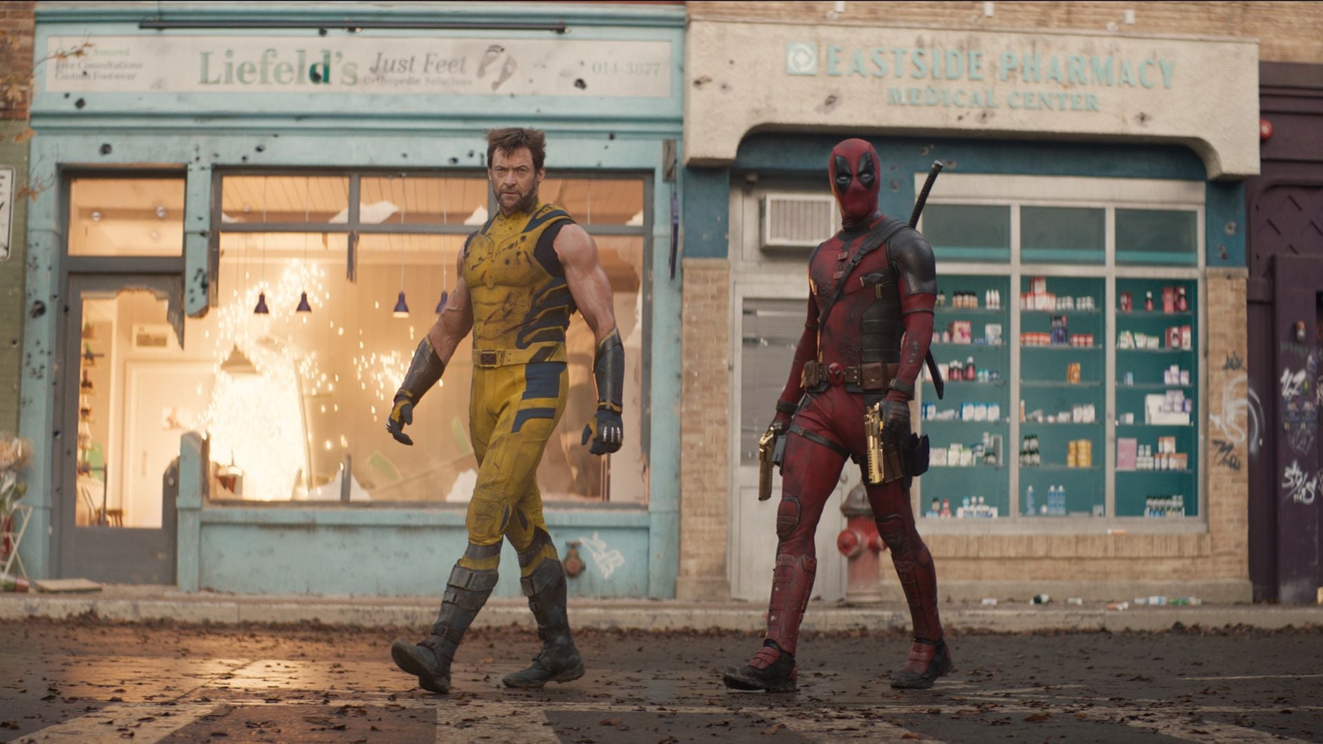 Logan and Wade Wilson walk out onto a deserted street in Marvel