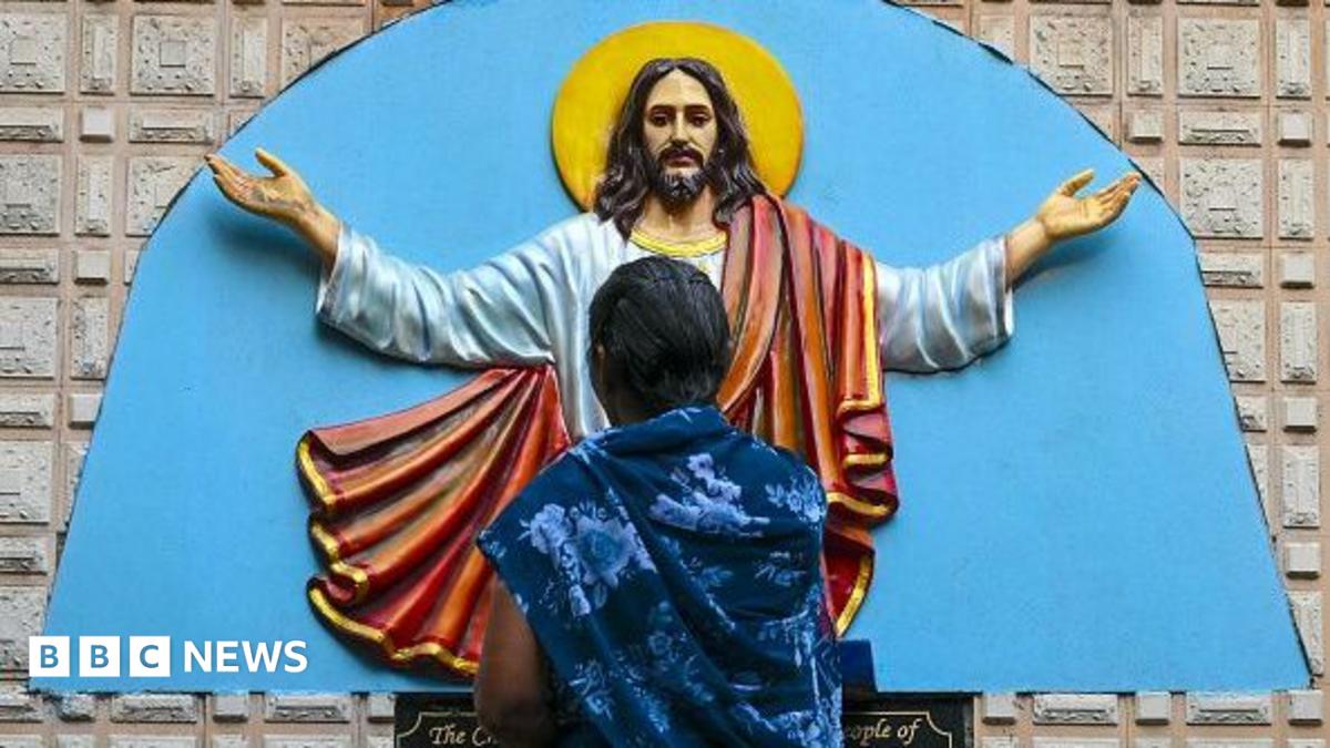 A Christian devotee prays in front of a statue of Jesus Christ during a Good Friday procession in Mumbai on April 3, 2026