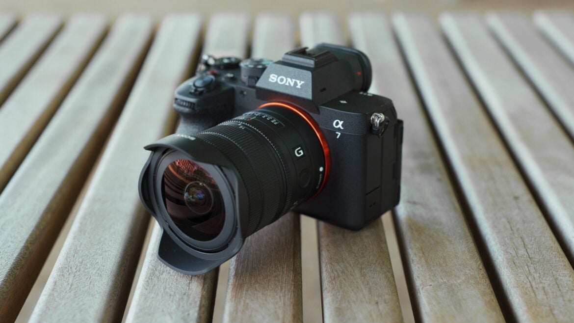 Sony Alpha mirrorless camera with the FE 8-14mm F3.5 G ultra-wide zoom lens resting on a wooden table