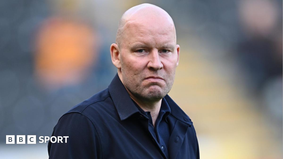 Henrik Pedersen, wearing a black jacket, looks straight-faced while on the touchline during Sheffield Wednesday's game at