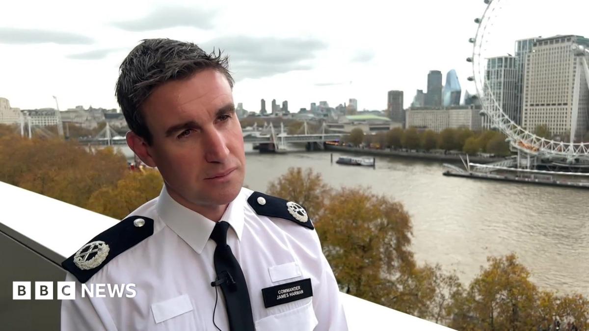 Deputy Assistant Commissioner James Harman is wearing a police uniform and standing with the River Thames behind him