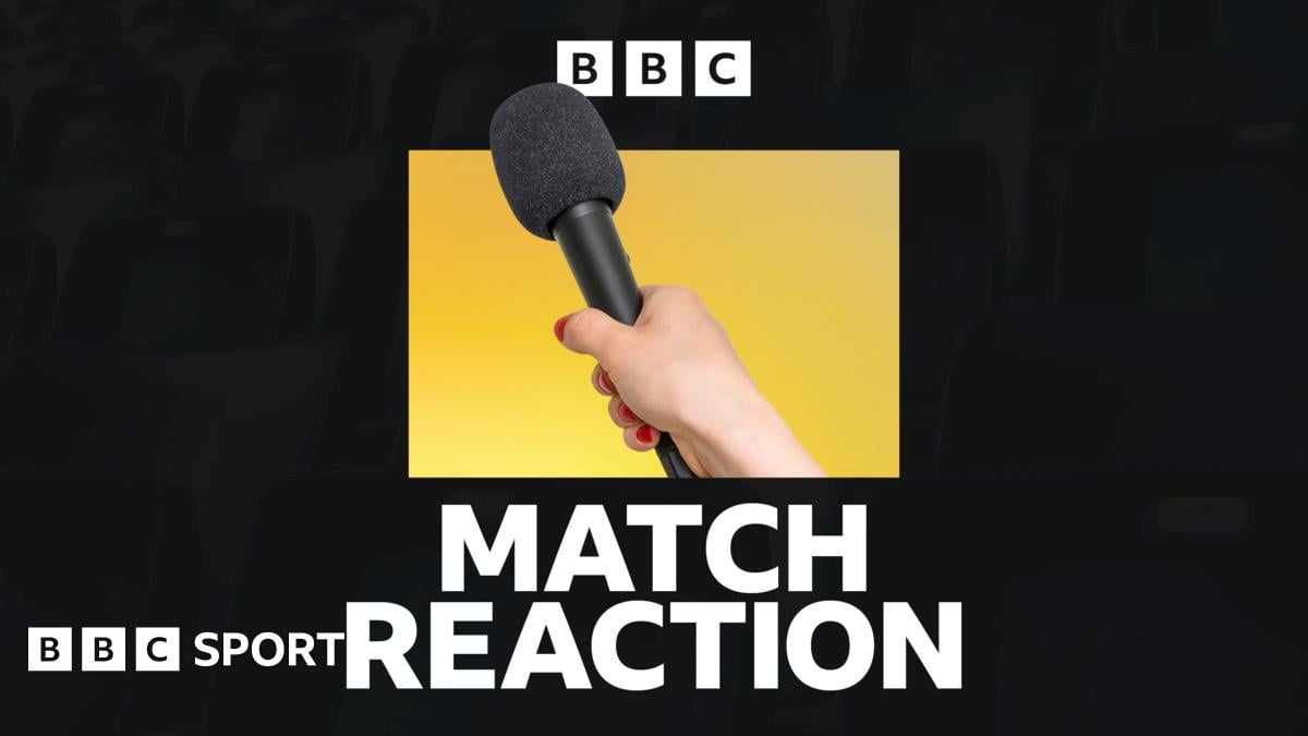 A hand holding a microphone, in front of a yellow and black background and above the words 'match reaction'