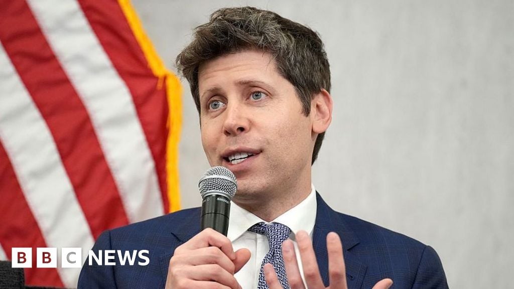 Sam Altman, CEO of OpenAI, speaks to an audience. He is seated in front of the American flag