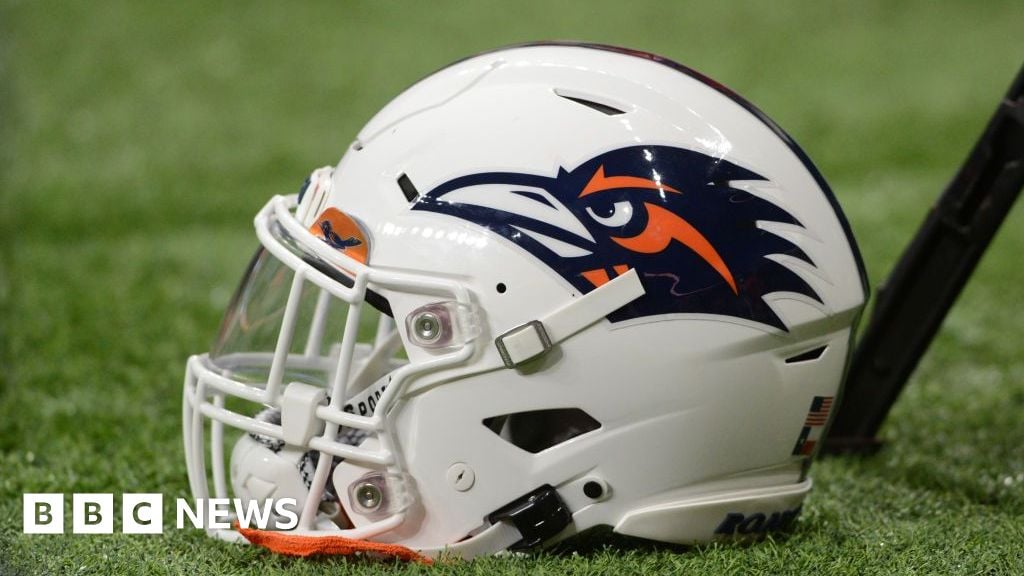 A photo of a University of Texas at San Antonio football helmet sitting on the turf