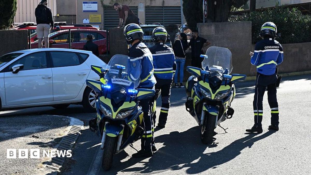 Three French police officers in uniform arrive at Lakanal school on motorbikes