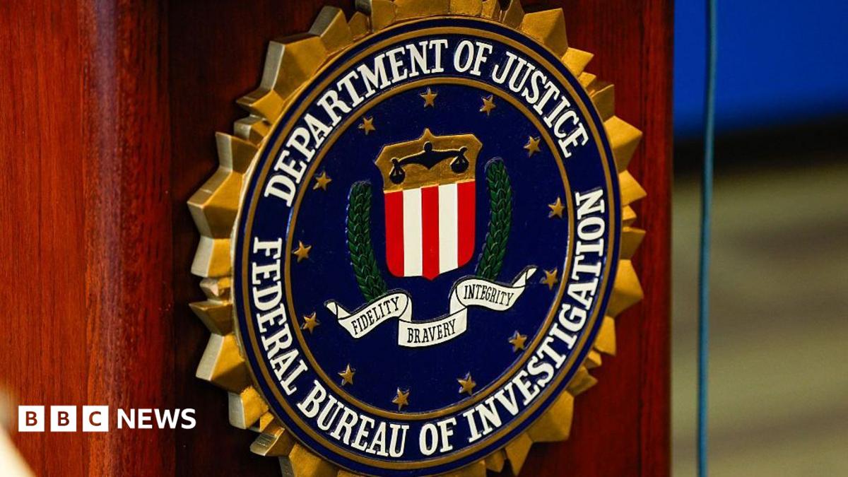 Close-up of a logo on a podium reading "Department of Justice, Federal Bureau of Investigation"