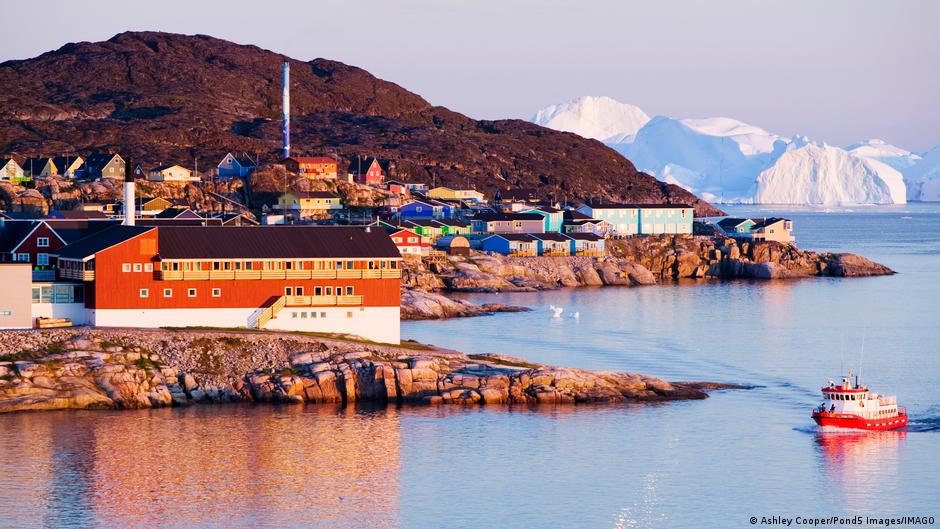 Colorful houses and a hospital in Ilulissat, Greenland, illuminated by the midnight sun