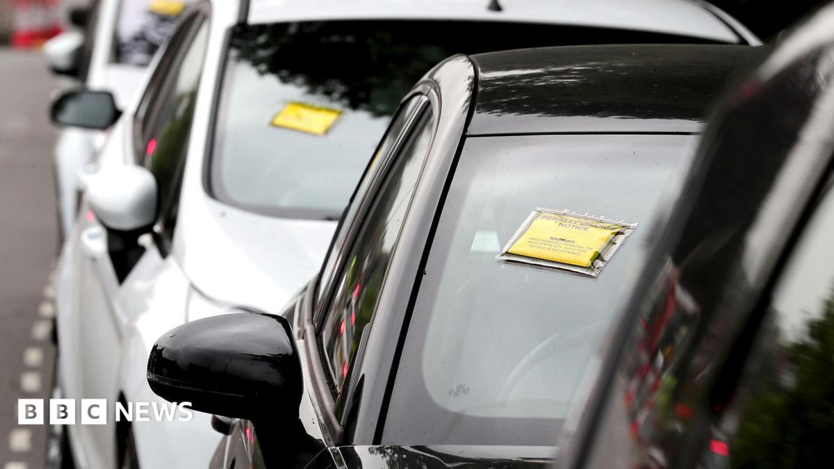 A generic-looking image shows a row of cars seen front-on with yellow and black Penalty Charge Notices affixed to their