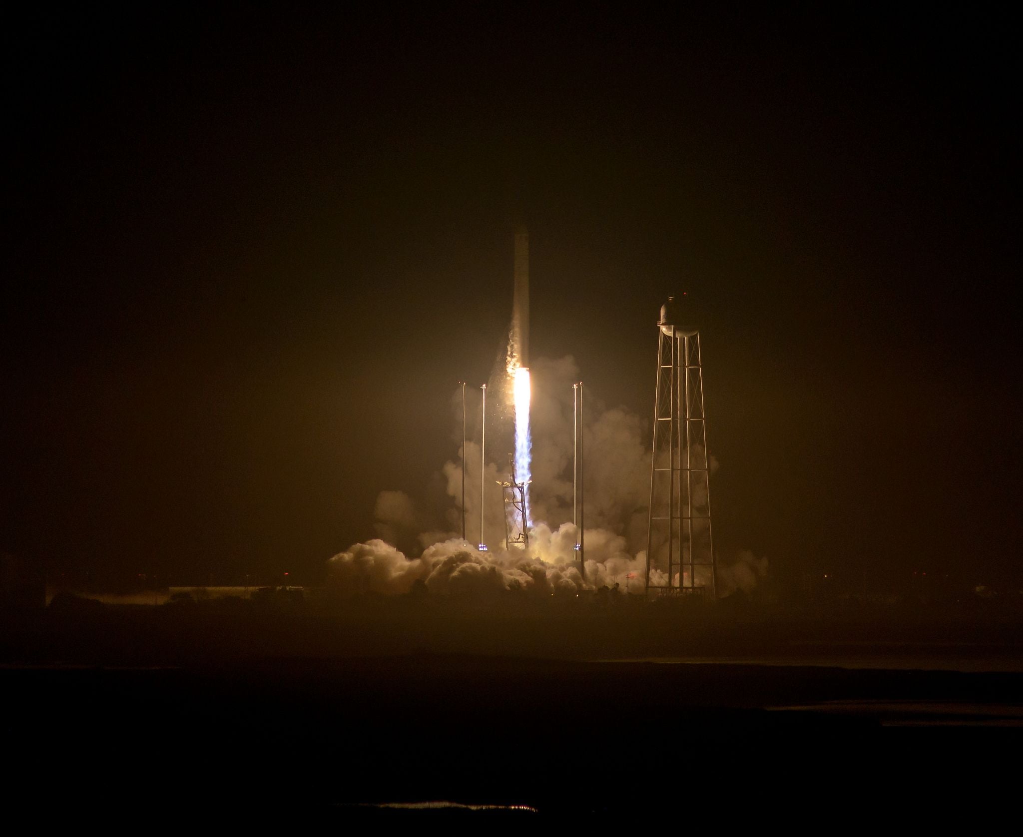 An upgraded Orbital ATK Antares rocket soars into the night sky over NASA