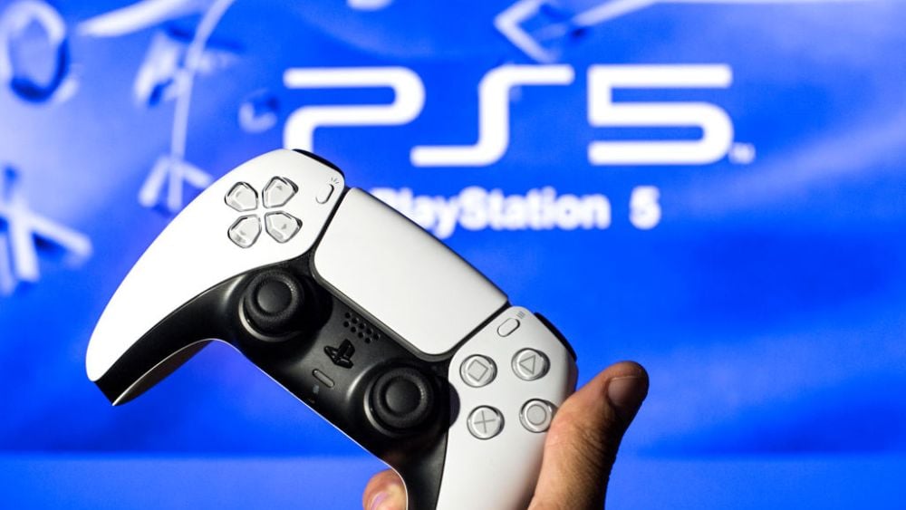 SPAIN - 2021/11/08: In this photo illustration, a PlayStation 5 controller seen with a PlayStation 5 logo in the background