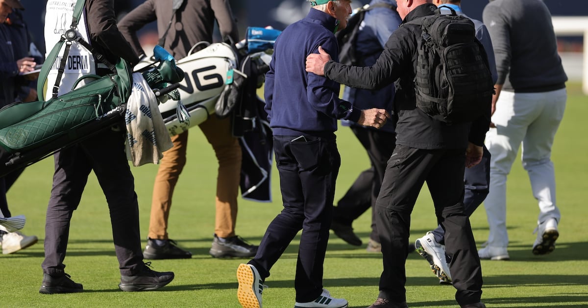 Dermot Desmond being escorted off the course at St Andrews due to the protest. Photograph: Steve Welsh/PA