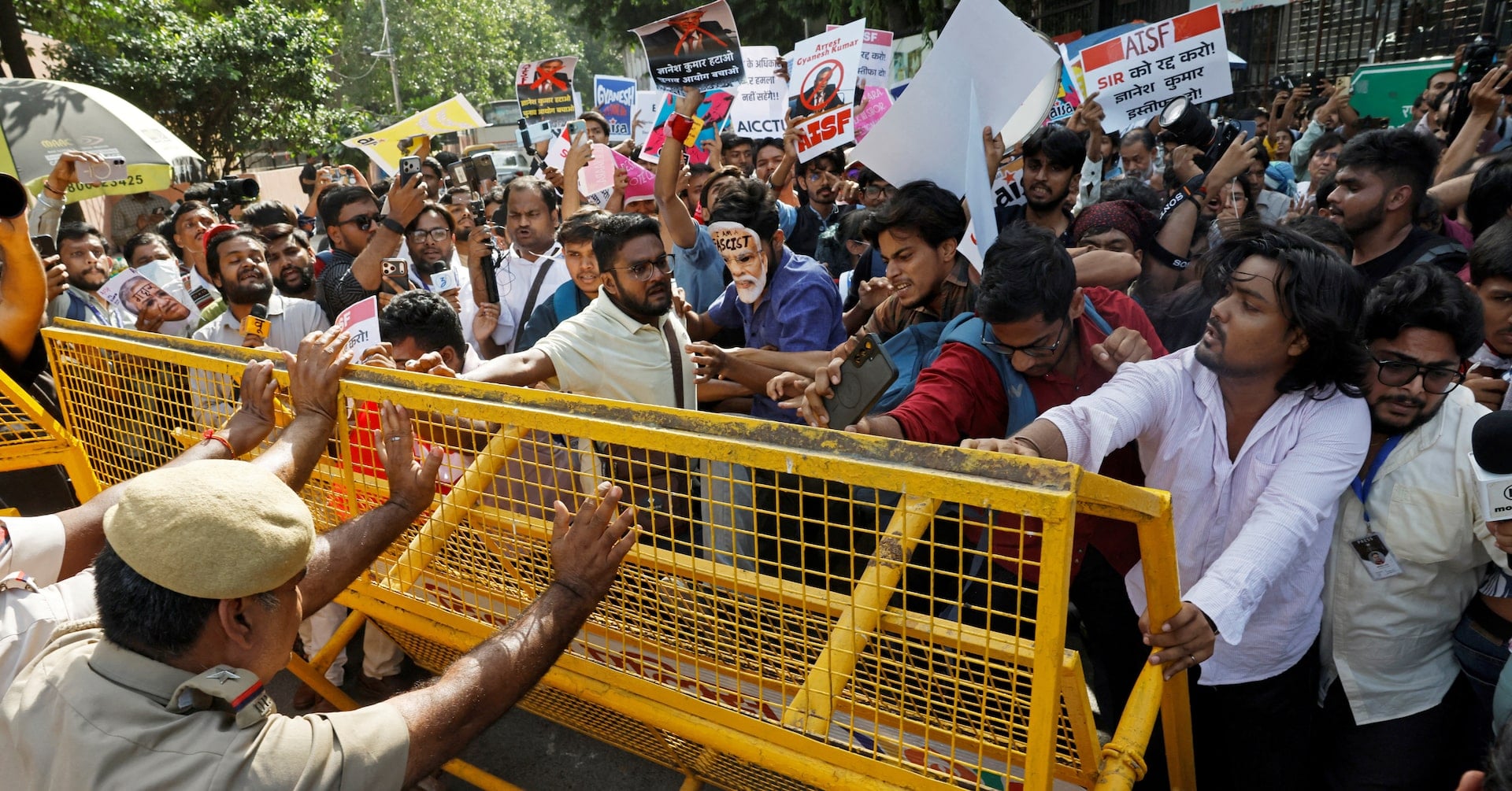 Demonstrators push against a police barricade during a protest demanding the resignation of India's Chief Election