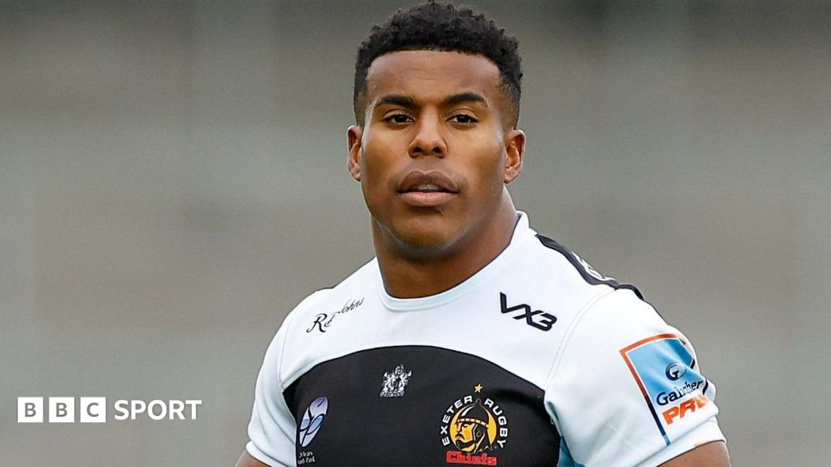Head and shoulders view of Immanuel Feyi-Waboso, wearing Exeter's largely white and black kit