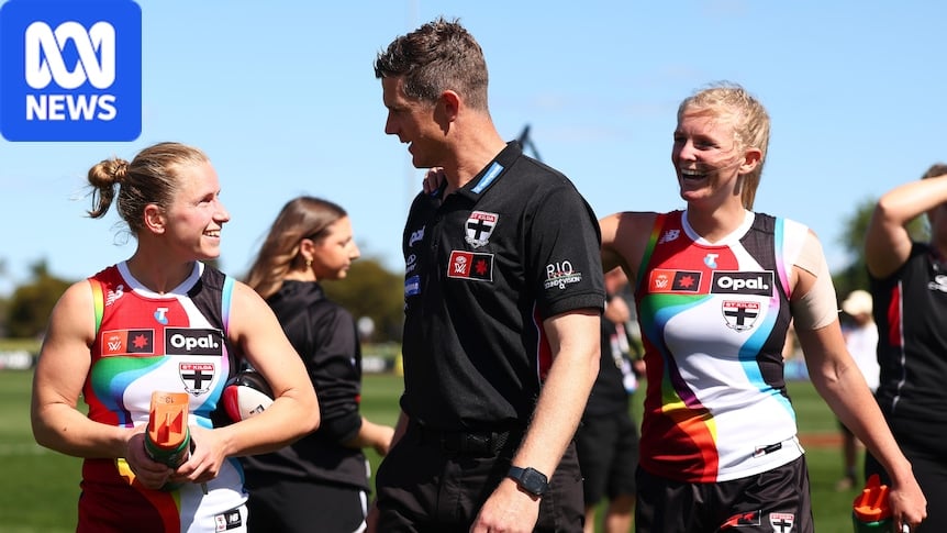 A coach leaves the field after winning an AFLW match