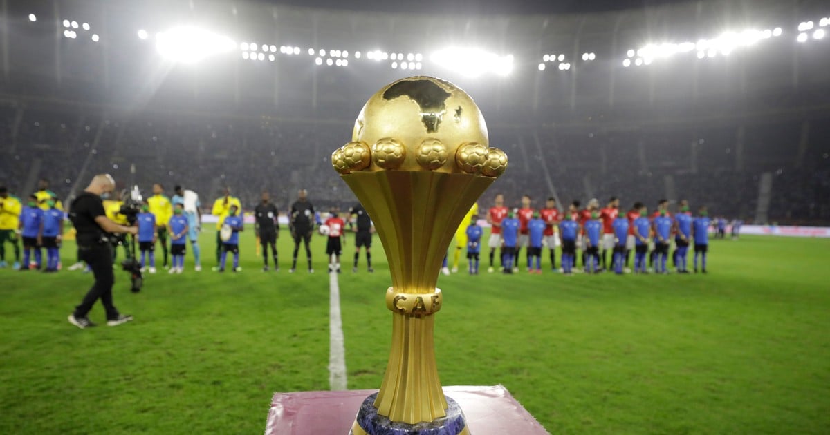 The Africa Cup of Nations (AFCON) trophy on display before kickoff as competing teams assemble on the pitch. (Photo: AFP via