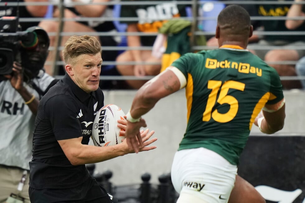 New Zealand's Damian McKenzie runs at South Africa's Damian Willemse during their rugby international in Baltimore, USA