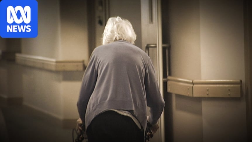 An older woman using a walker has her back to the camera