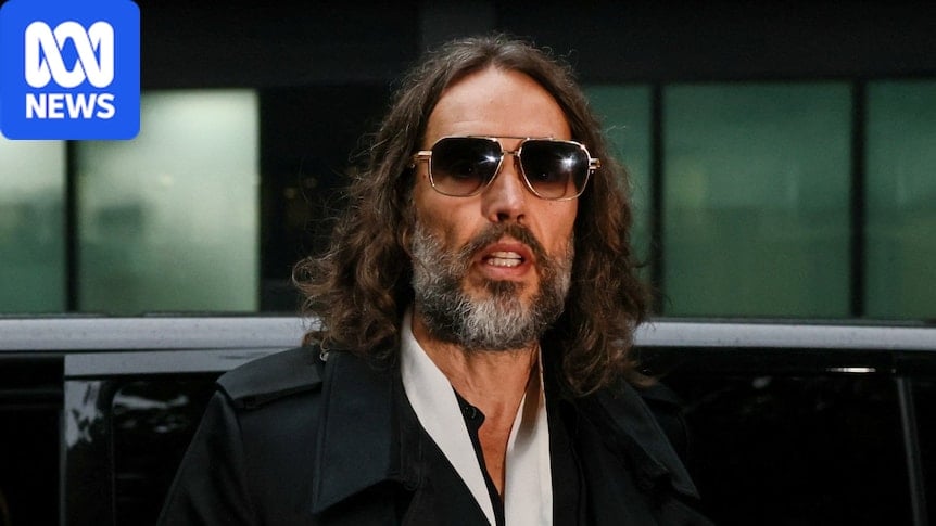 a man with large sunglasses on, looking on
