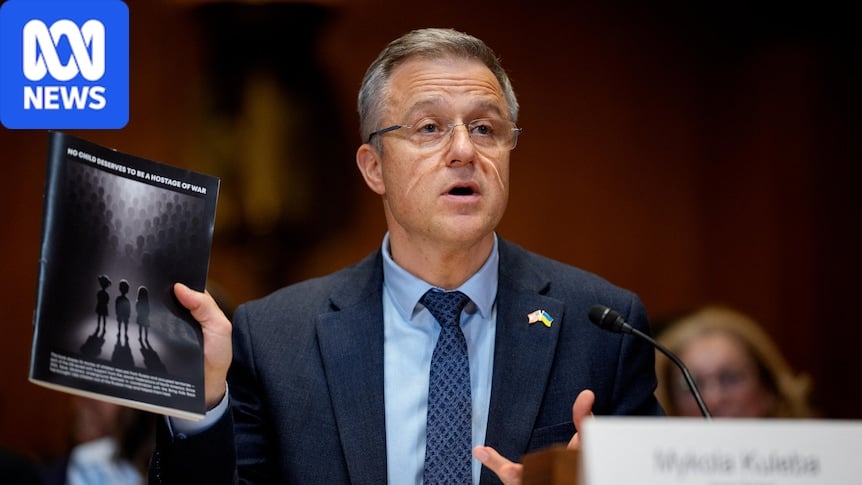 Save Ukraine co-founder Mykola Kuleba holds up book at US Senate hearing