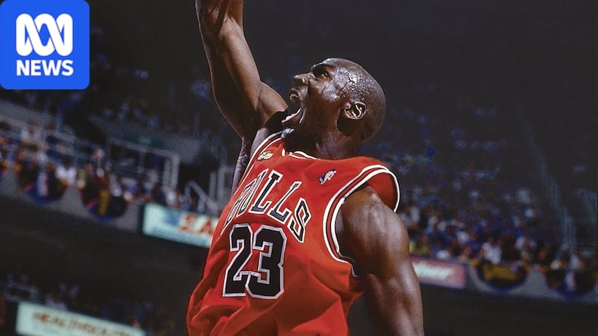 Michael Jordan dunking the basketball in a match, roaring as he scores